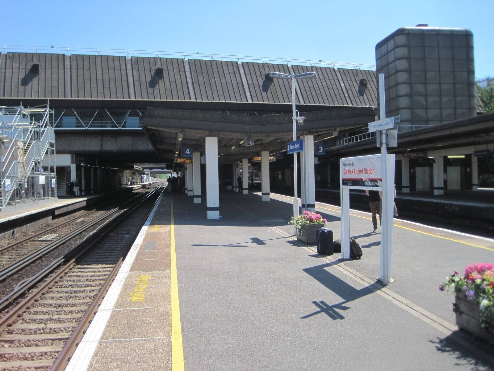 A sunny platform at Gatwick train station, with the Welcome to Gatwick Airport Station sign