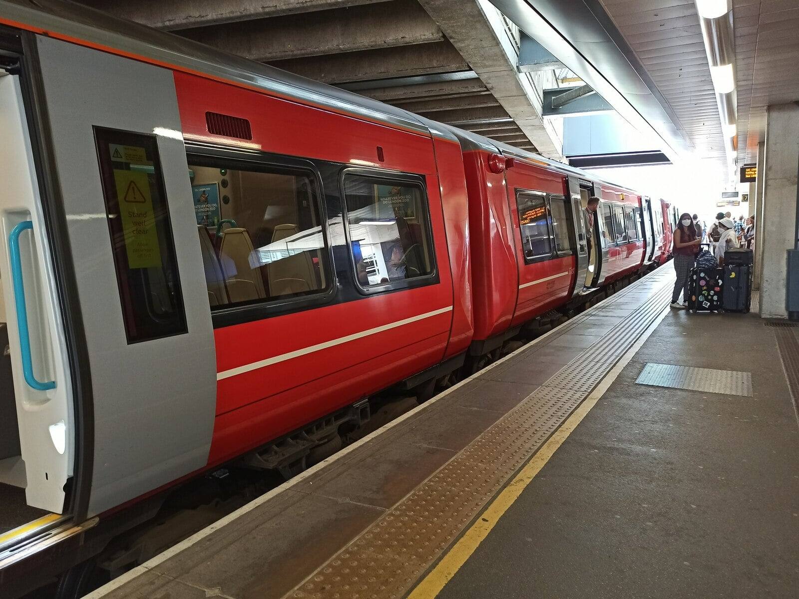 A red Gatwick Express Class 387 train at a platform at Gatwick Airport station