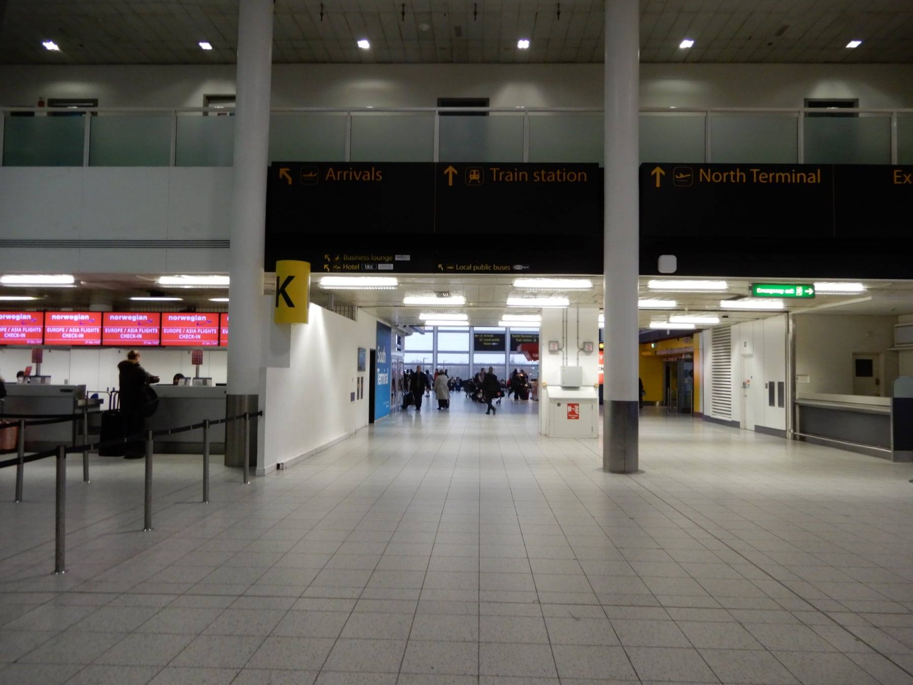 The concourse at Gatwick South Terminal, with signs to arrivals and the train station