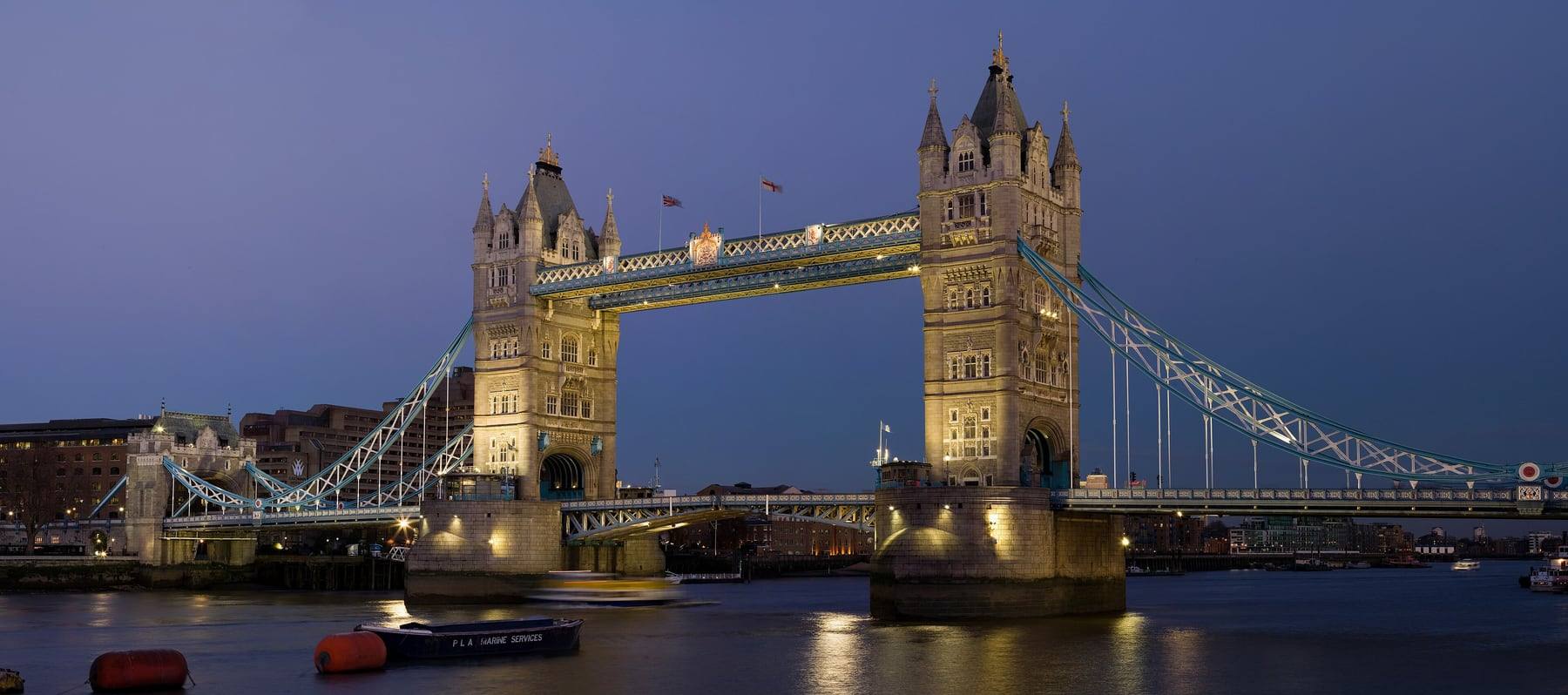 Tower Bridge lit at dusk over the Thames in central London, at the London end of the Gatwick to London route